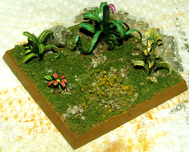 Finished terrain base covered with colourful miniature plants carved from plastic model sprues